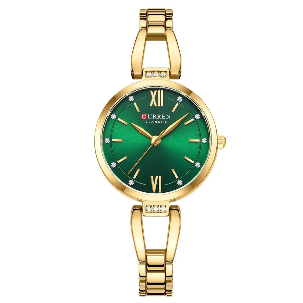 Gold watch with a green face on a white background